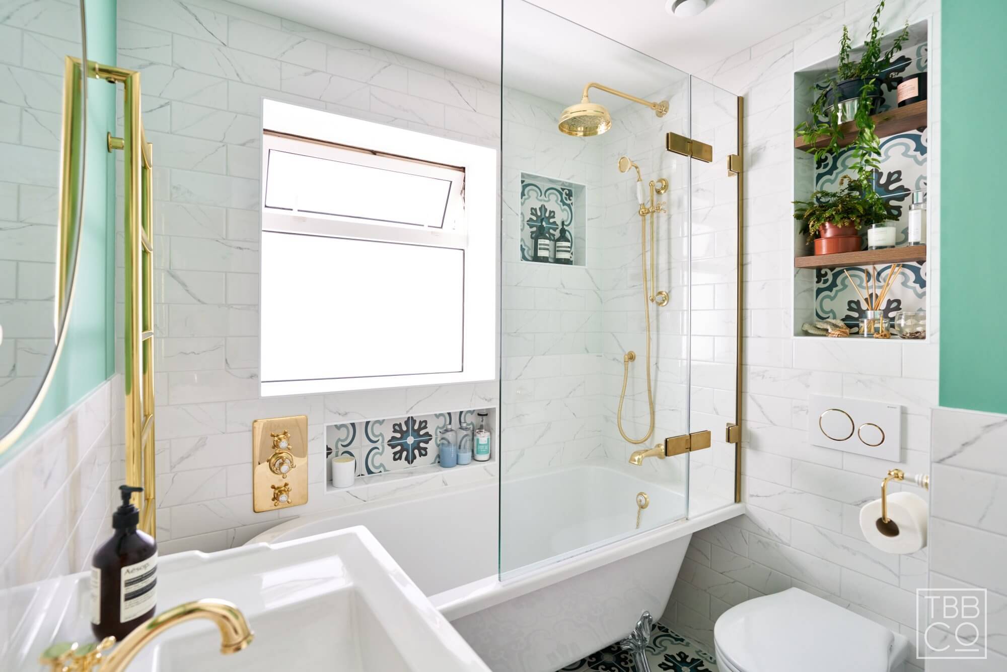 Bath with Patterned Tiles, Gold Shower Valve and Bath Screen