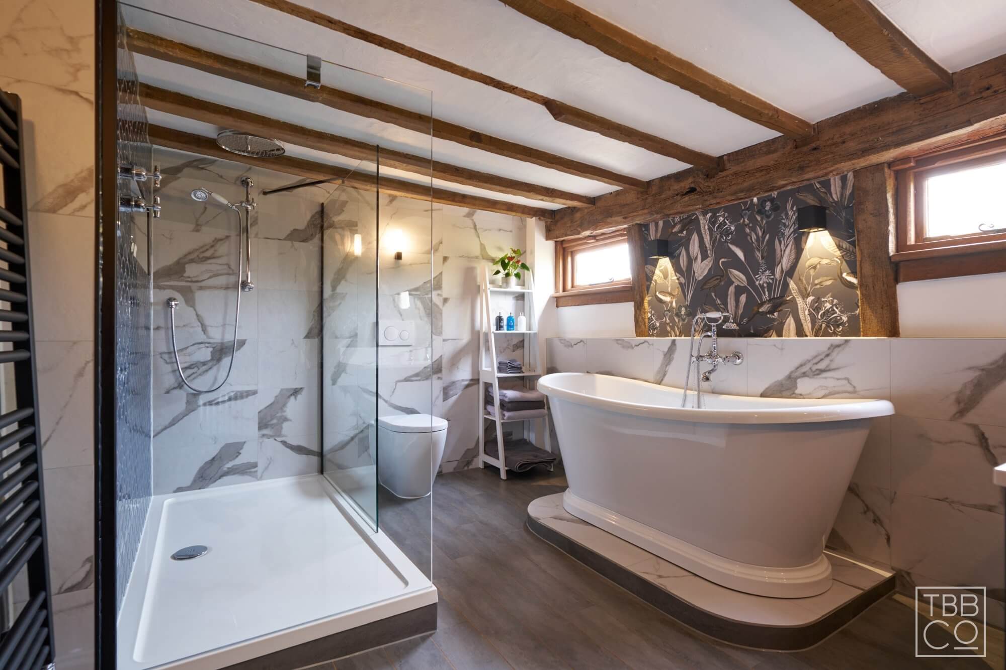 Bathroom Design with Boat Bath on Plinth with feature wallpaper