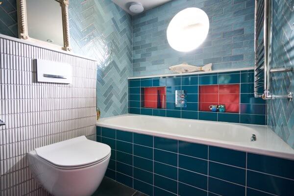Bath with feature recesses and blue and red tiles